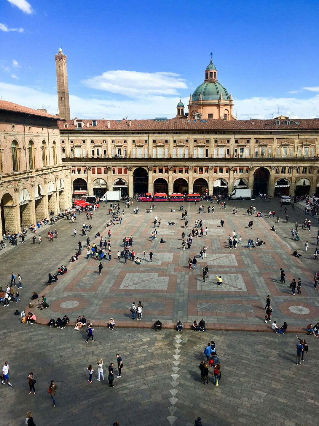 Historic plaza with a stone fountain surrounded by people