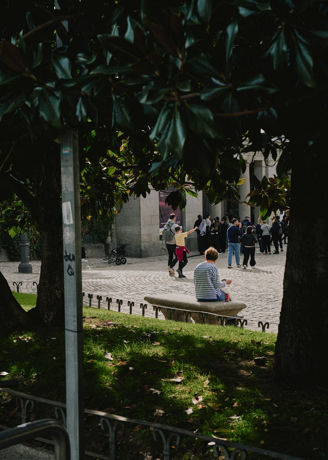 Chilean university student studying on a bench in a public square