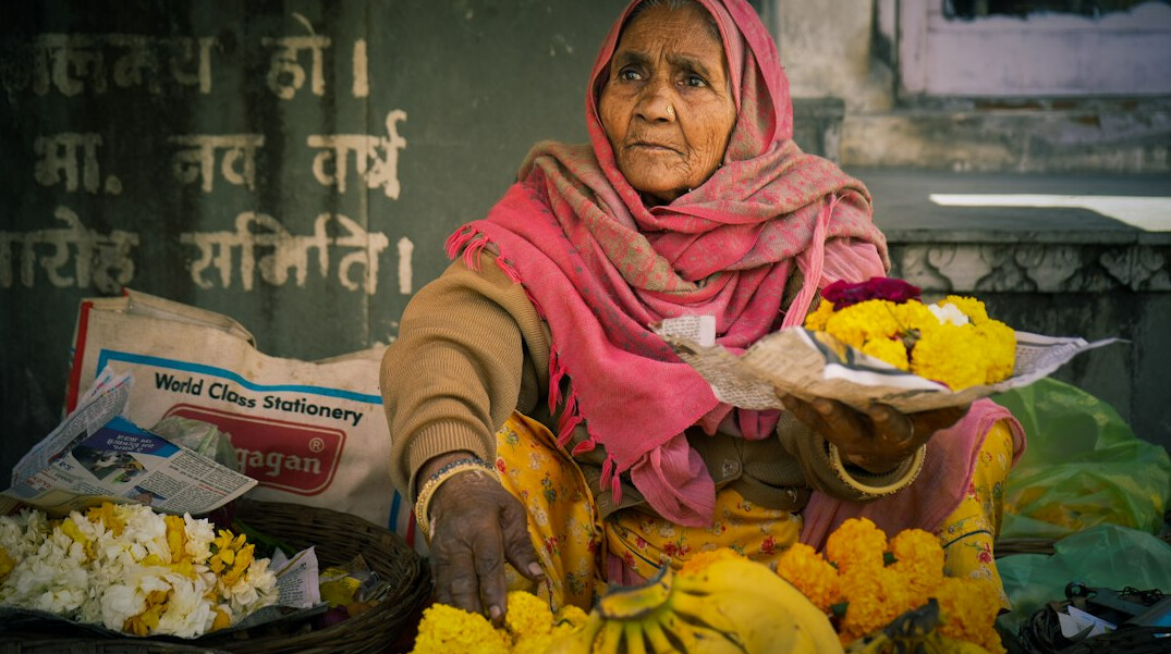 Elderly Chilean woman selling flowers at a market stall
