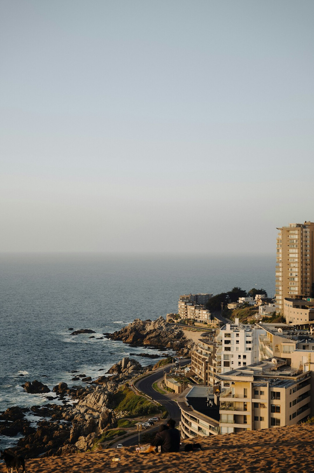 Coastal boardwalk in Valparaiso with colorful houses in the background